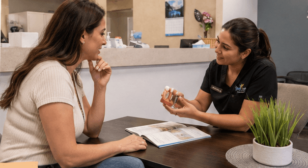 A Smile Loft Dental team member talking through implant options with a patient