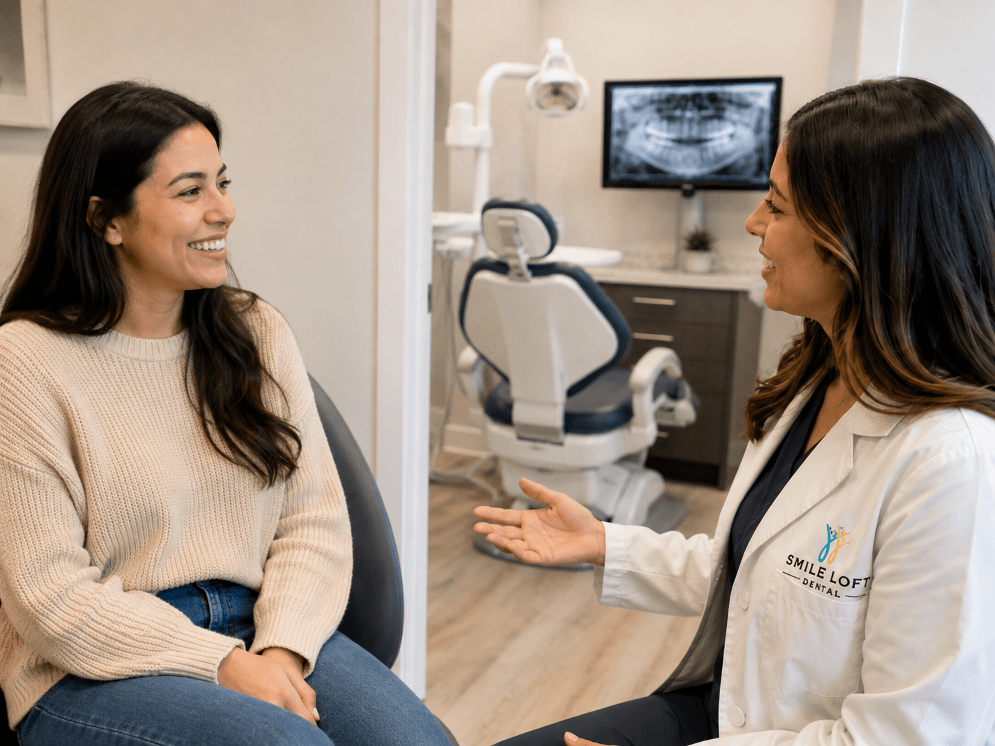 A Smile Loft Dental team member talking through findings with a patient after their exam