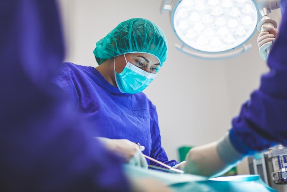 Dentist and patient smiling together during a friendly checkup