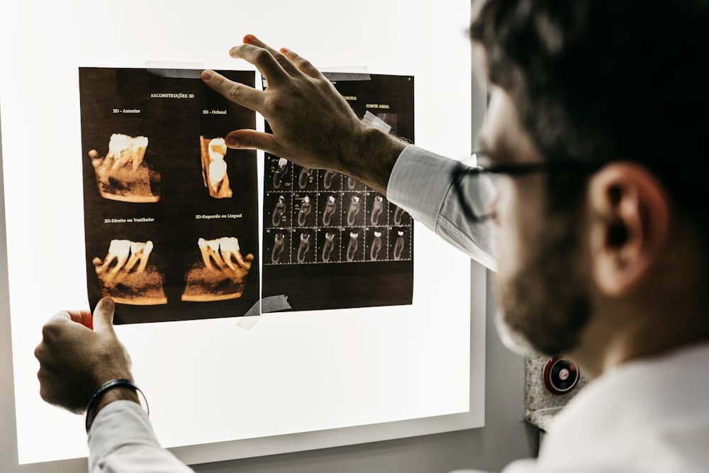 Dental team member reviewing X-ray images with a patient