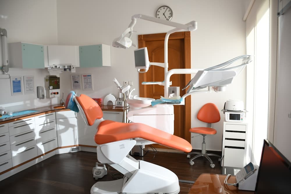 Dental professional holding a tooth model while explaining treatment